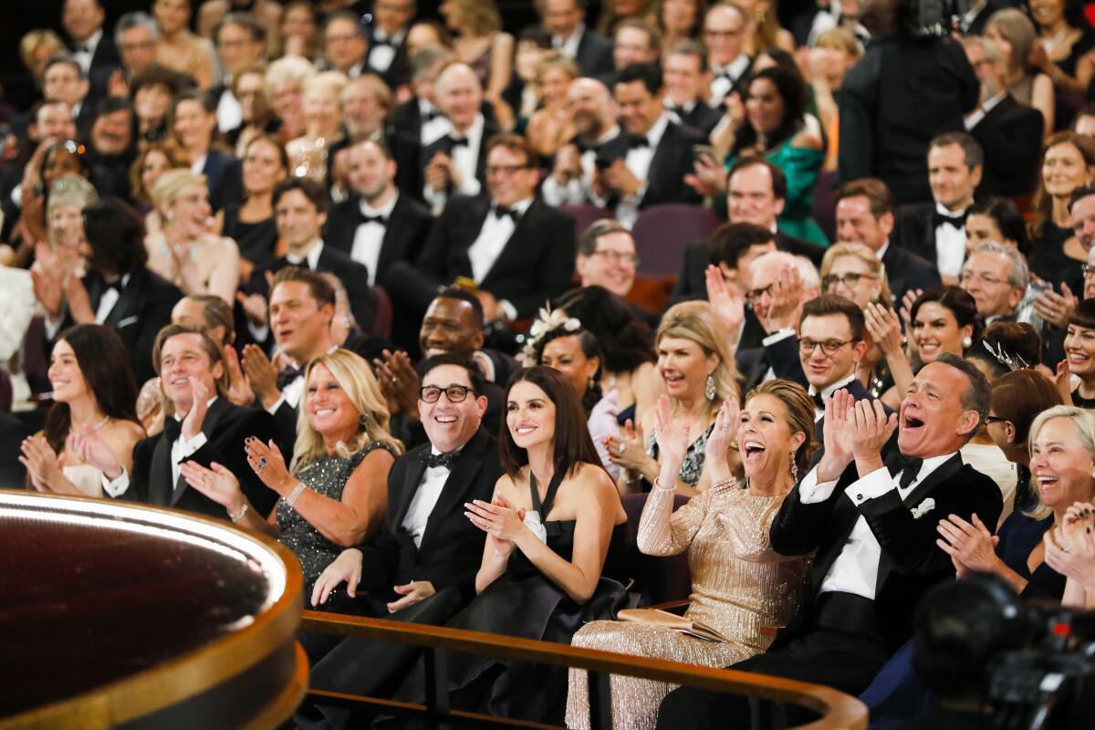 Audience members including Tom Hanks, Rita Wilson, Penélope Cruz and Brad Pitt react to "Parasite" winning best picture as seen from backstage at the 92nd Academy Awards.