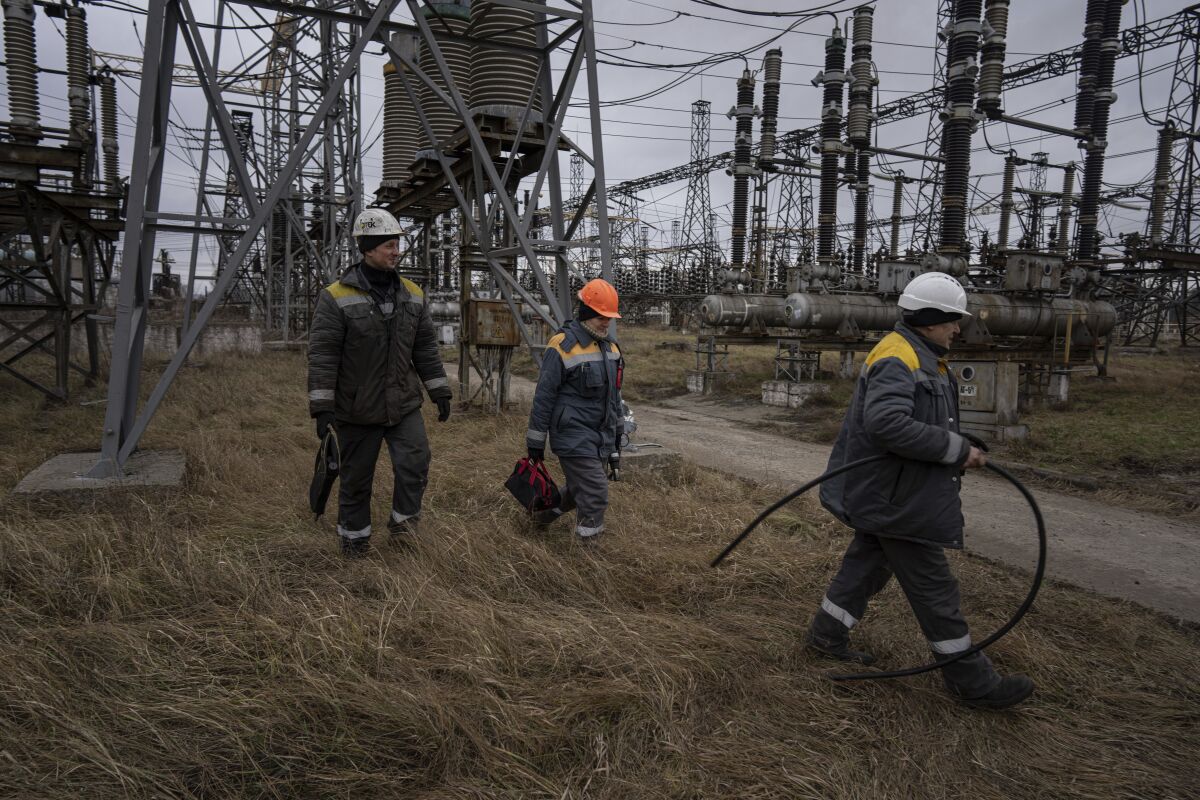 Workers repairing damage at a power plant