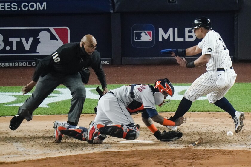 New York Yankees' Rougned Odor runs past Houston Astros catcher Martin Maldonado to score during the sixth inning of a baseball game Tuesday, May 4, 2021, in New York. (AP Photo/Frank Franklin II)