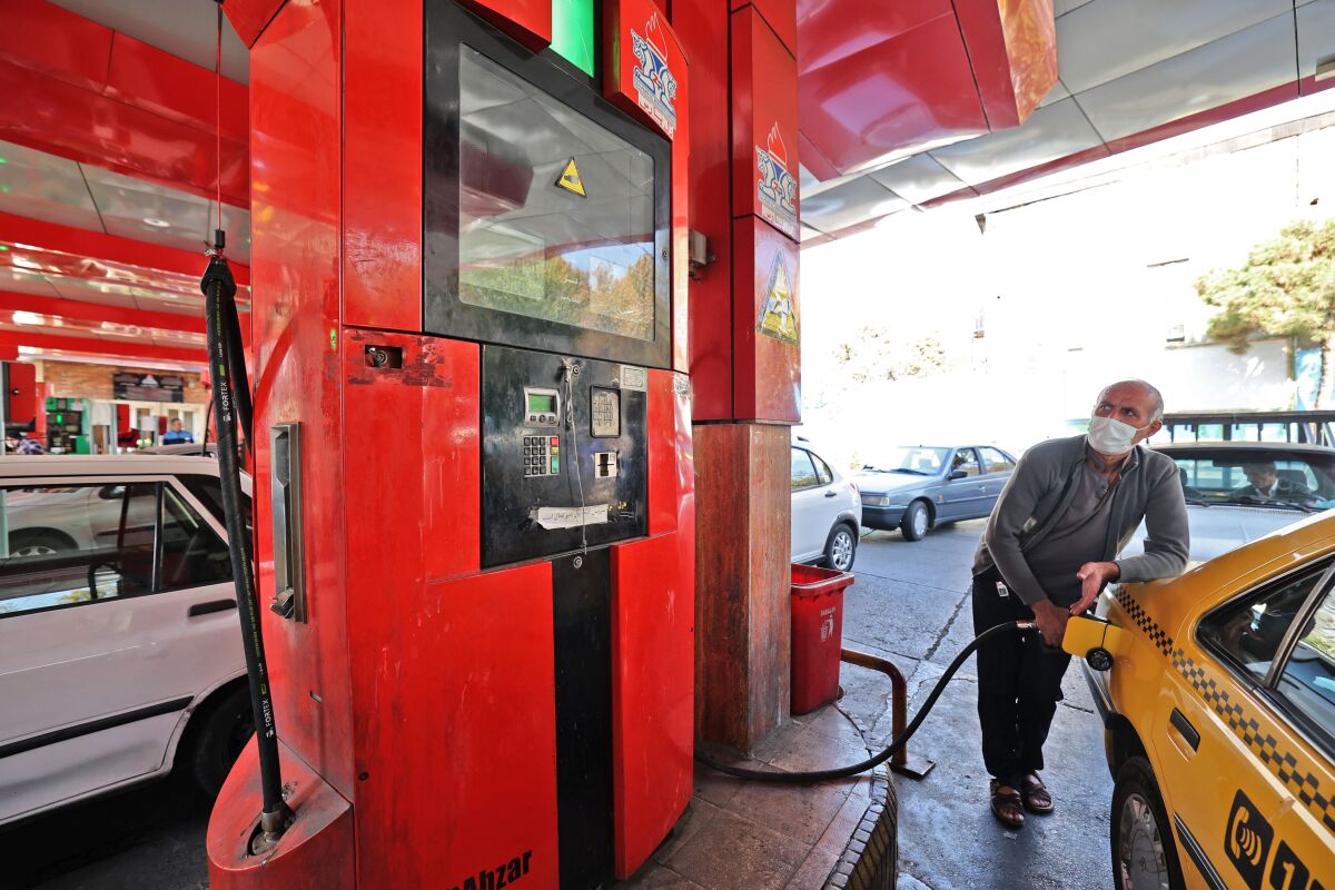 Man filling up car at a gas station