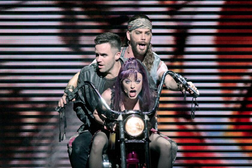 Ruby Lewis as Scaramouche, front to back, Brian Justin Crum as Galileo and Ryan Knowles as Buddy in "We Will Rock You" at the Ahmanson Theater.