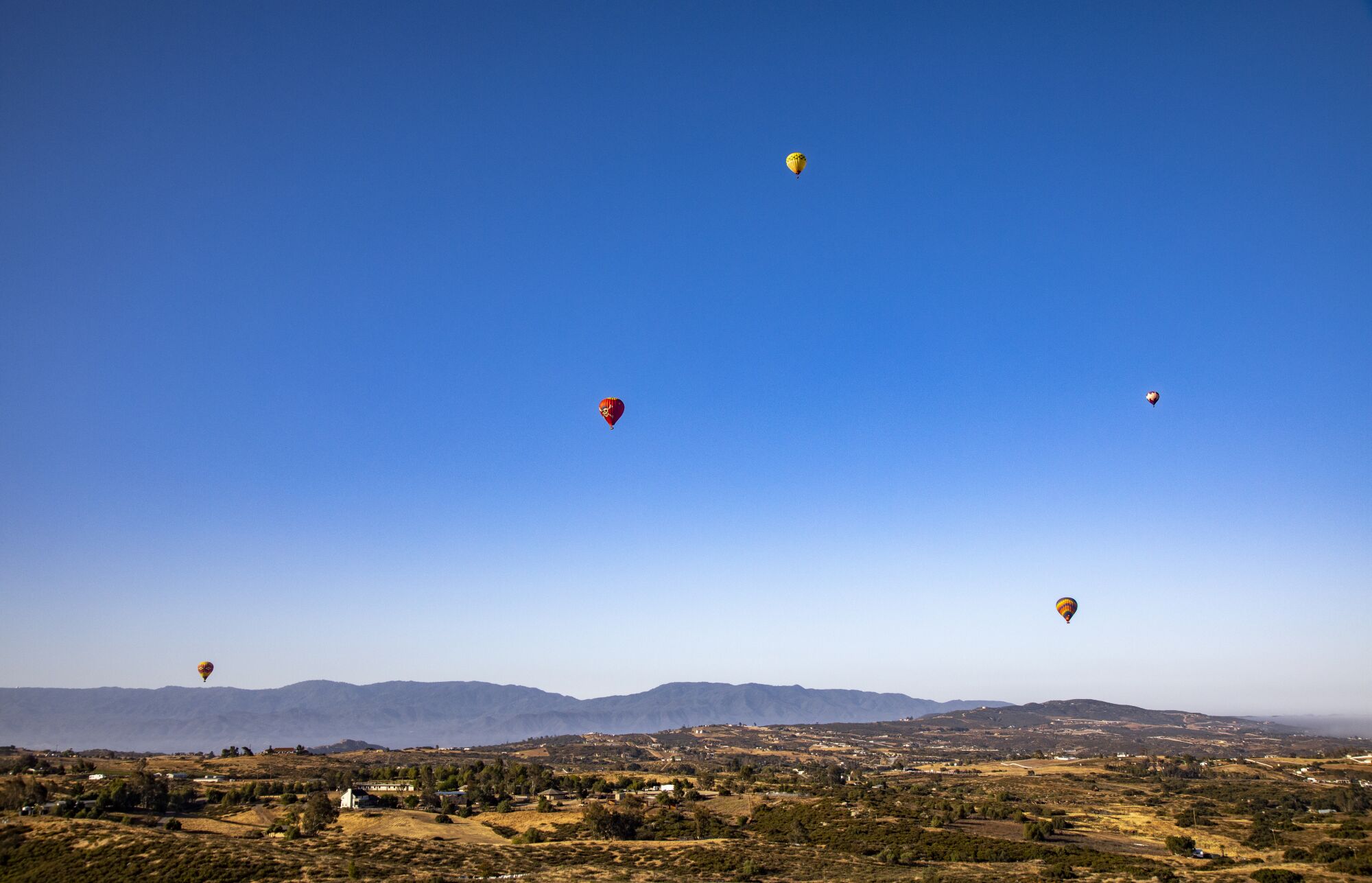 Hot air balloons drift skyward.