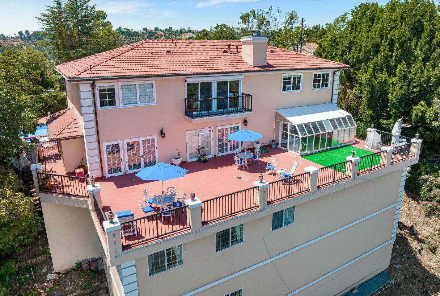 The four-story home has a deck in the back on an upper floor that is furnished.