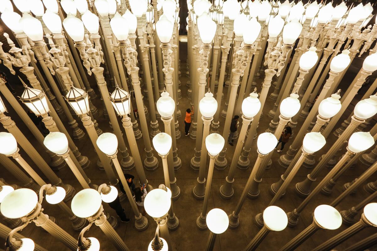 An overhead view shows people taking pictures inside Chris Burden's "Urban Light" at LACMA.