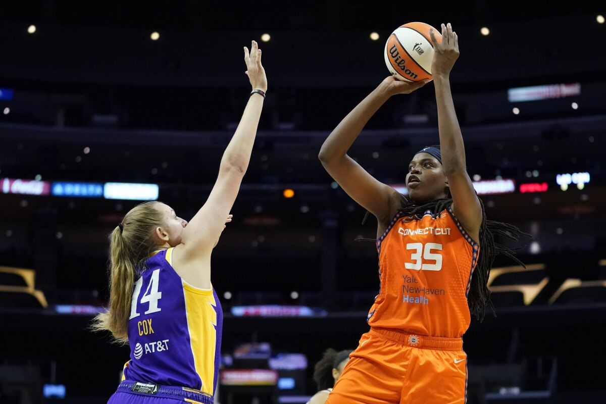 Connecticut Sun forward Jonquel Jones (35) shoots over Los Angeles Sparks forward Lauren Cox (14) during the first half of WNBA basketball game Thursday, Sept. 9, 2021, in Los Angeles. (AP Photo/Ashley Landis)
