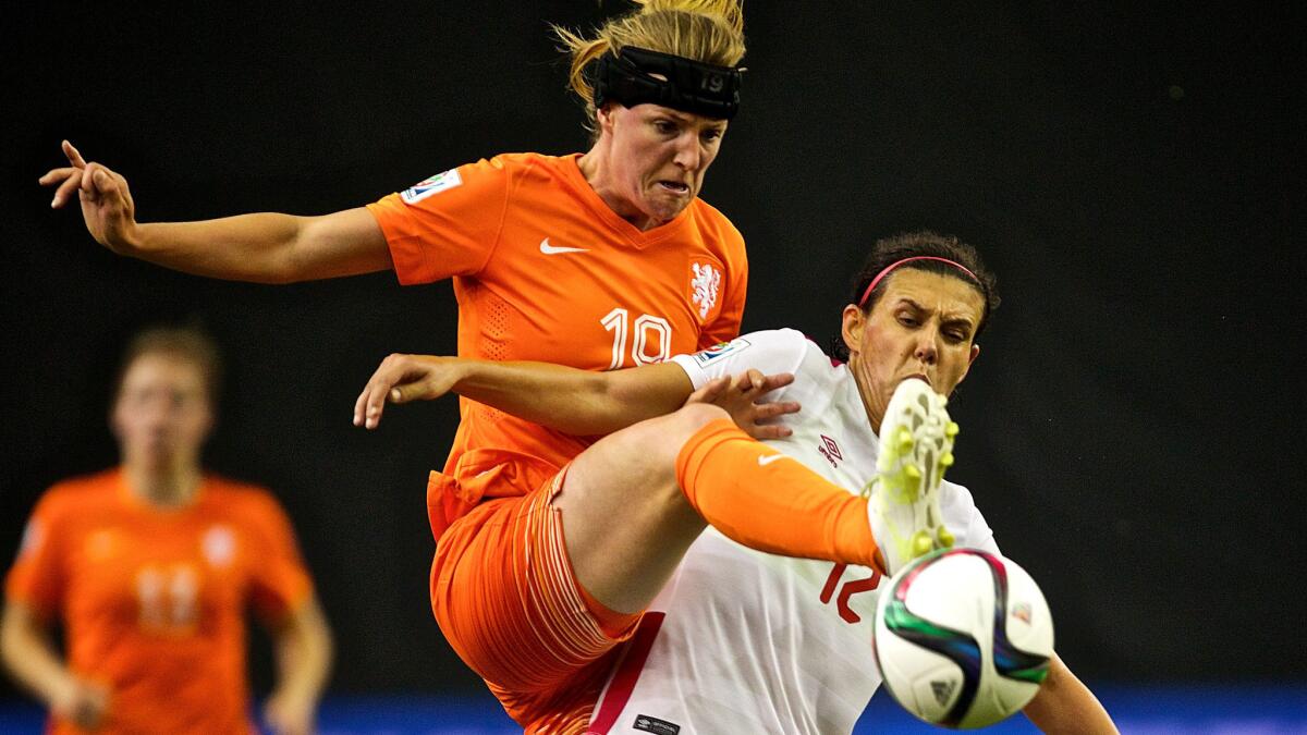 Netherlands midfielder Kirsten Van De Ven tries to kick away a pass intended for Canada forward Christine Sinclair in the second half of their Women's World Cup group game on Monday.