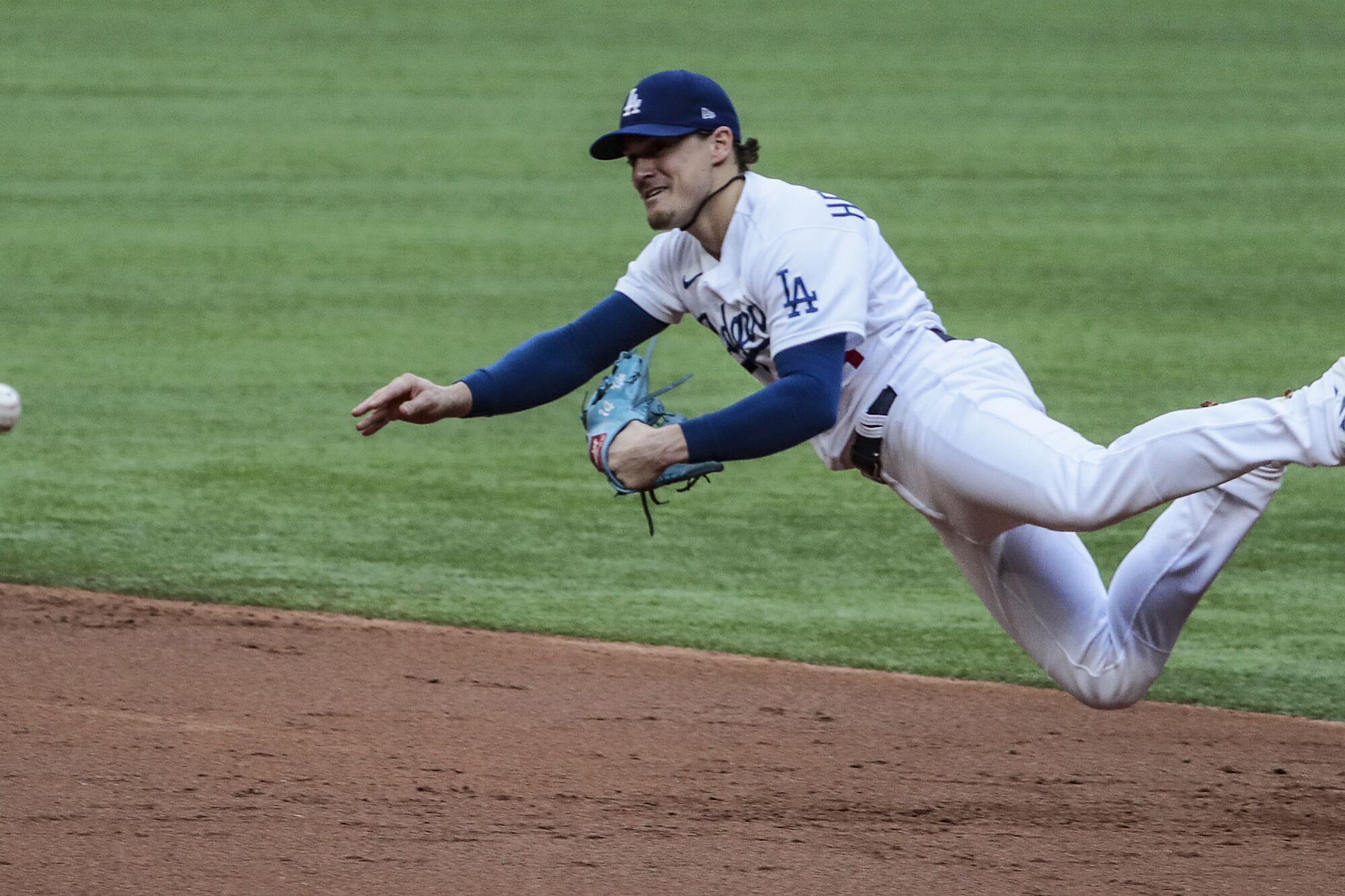 Dodgers second baseman Kiké Hernández tries to make a throw to first during the second inning.