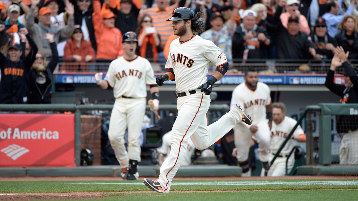 San Francisco's Brandon Crawford scores the winning run of a 5-4 victory over the St. Louis Cardinals in Game 3 of the National League Championship Series on Tuesday.