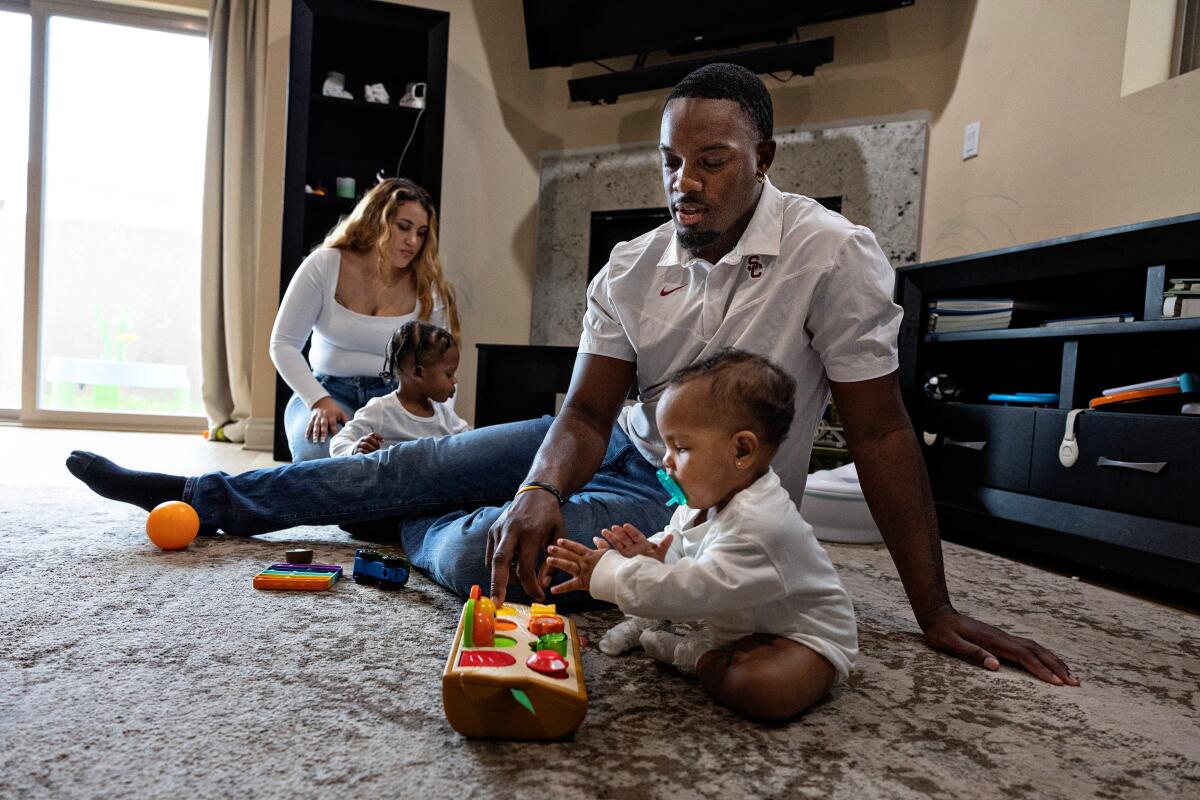 Solomon Byrd and his wife, Taysia, enjoy evening play time with their 2-year-old son Messiah and infant daughter Bleu.
