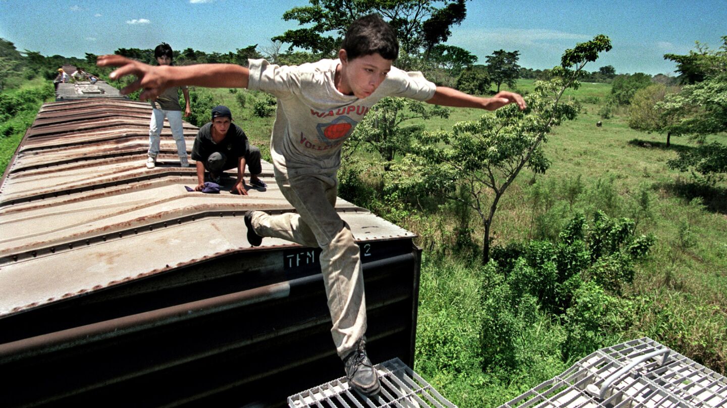 Denis watches 13-year-old Jose Padilla Guerra make his first leap between cars of a moving freight train in Chiapas, Mexico, in August 2000. His lesson to other stowaway kids: "Don't look down between the train cars. It'll make you afraid."