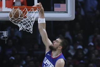 Clippers center Ivica Zubac dunks in front of Phoenix Suns center Jusuf Nurkic at Crypto.com Arena.