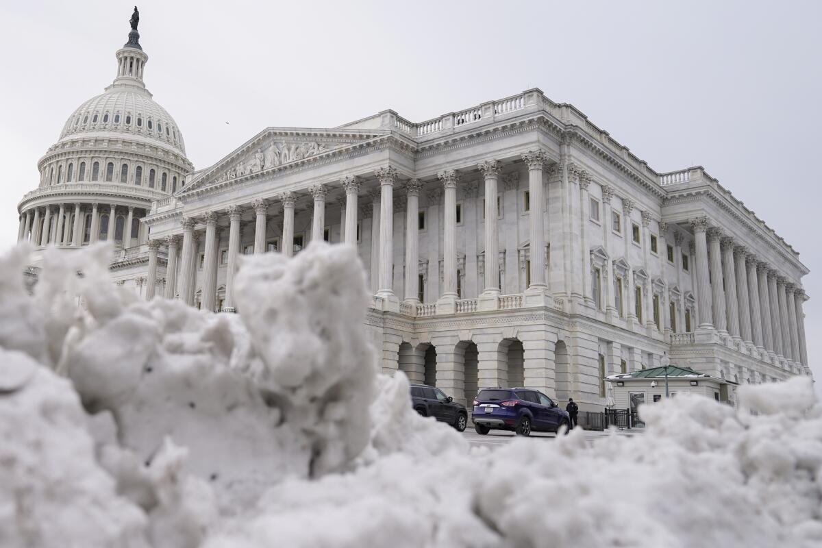 The U.S Capitol behind piles of snow in Washington. 