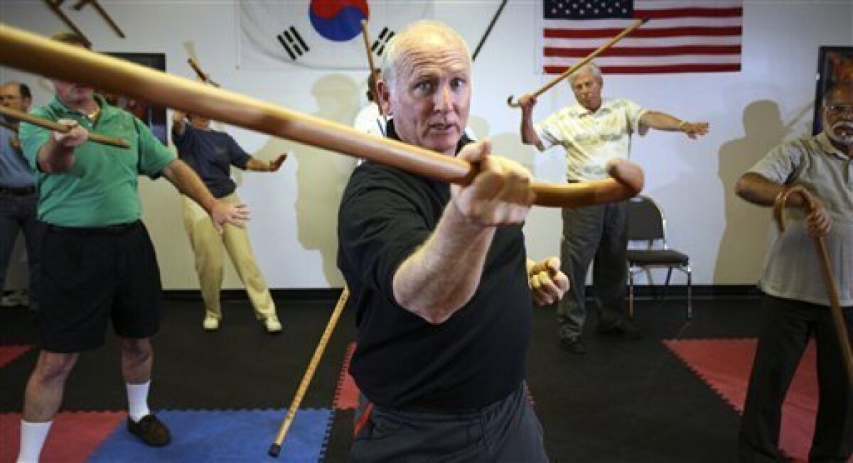 Grand Master Mark Shuey, center, teaches a self-defense seminar on Cane-Fu, defending yourself with a simple walking cane, at the Gary Hernandez Martial Arts studio on Sunday, Feb. 15, 2009 in Zephyrills, Fla. (AP Photo/Craig Litten)
