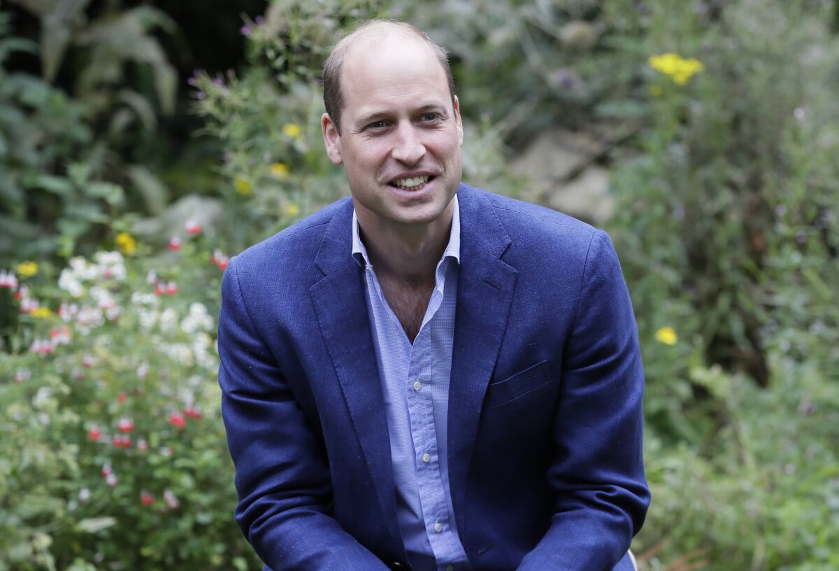 FILE - In this Thursday, July 16, 2020 file photo, Britain's Prince William speaks with service users during a visit to the Garden House in Peterborough, England. Prince William has criticized some of the world’s richest men for using their wealth to fund a new space race and space tourism, and called on the world's great minds to fix the planet first. The Duke of Cambridge spoke to the BBC about climate anxiety, COP26, space travel, and his family's long-standing commitment to environmental issues ahead of his inaugural Earthshot prize awards ceremony Sunday, Oct. 17, 2021.(AP Photo/Kirsty Wigglesworth, file)