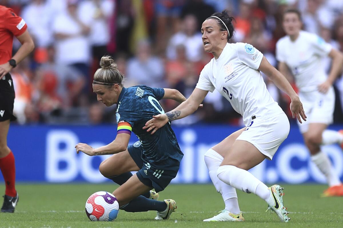 Germany's Svenja Huth, left, challenges England's Lucy Bronze for the ball during the Women's Euro 2022 final.