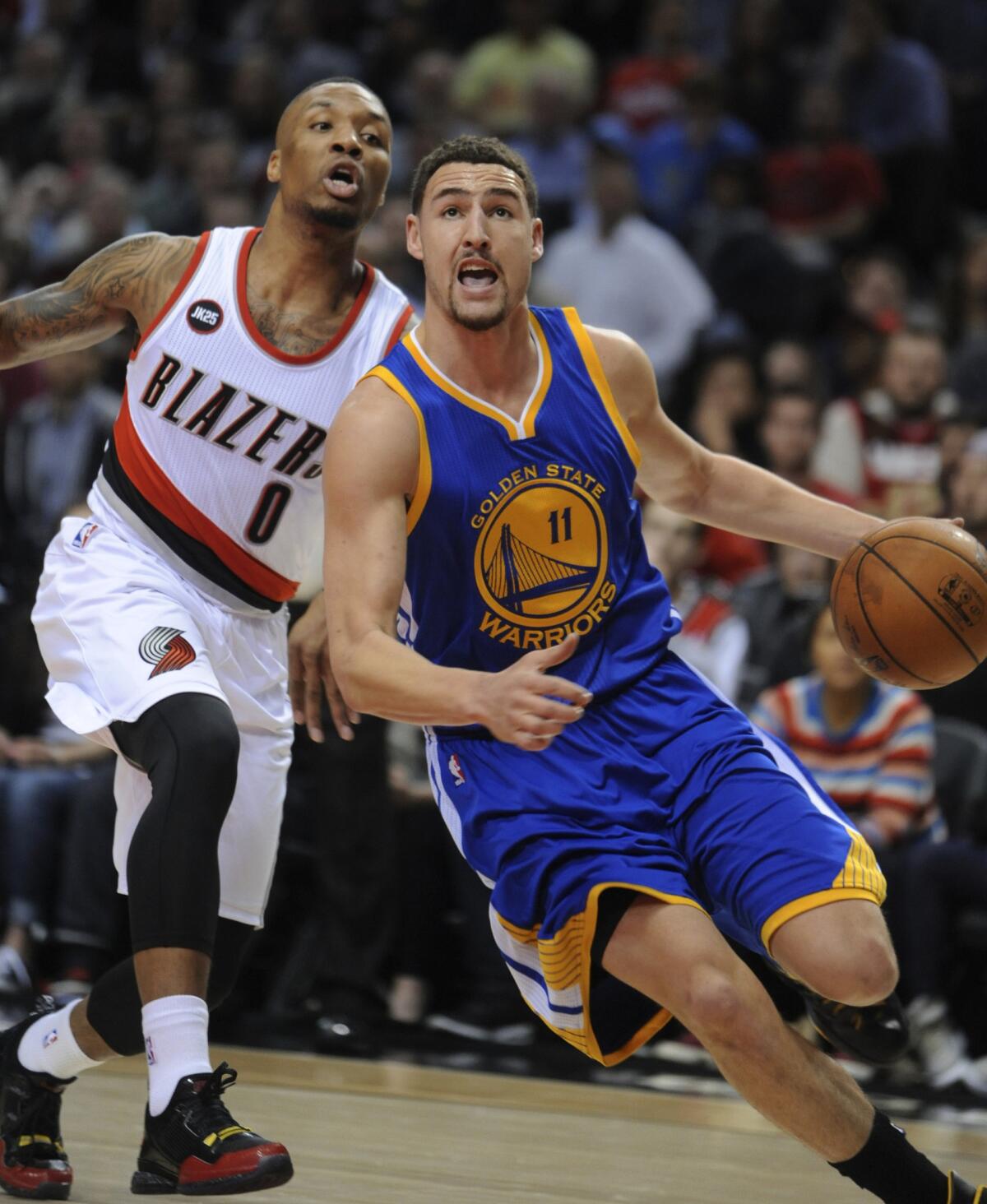 Golden State guard Klay Thompson drives past Portland guard Damian Lillard during the first half of the Warriors' Pacific Division clinching win over the Trail Blazers, 122-108, on Monday.