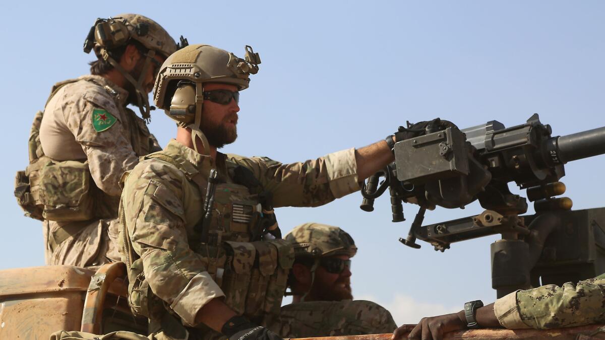 U.S. Special Forces operators ride in the back of a pickup truck in the northern Syrian village of Fatisah on May 25.