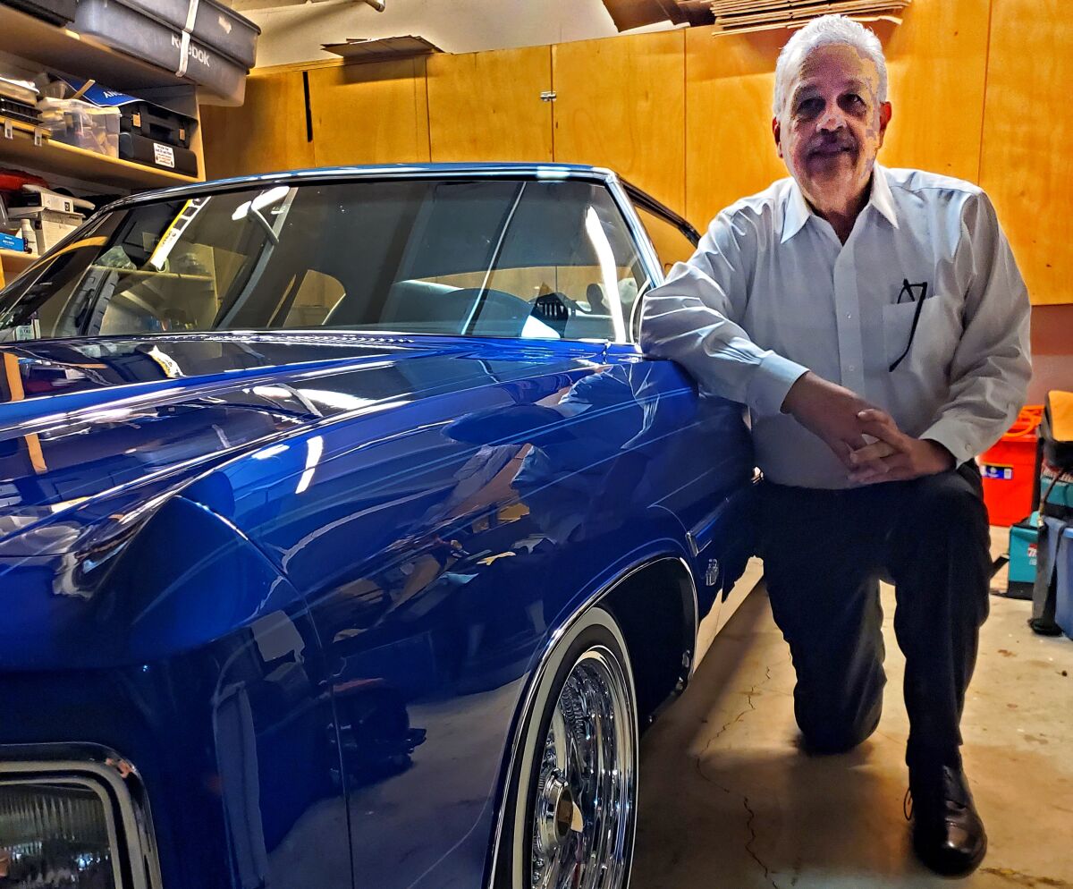 Eugene Hernandez, president of the Imperials Car Club, with his lowrider.