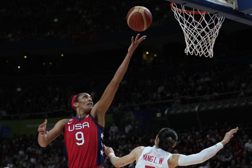 United States' A'ja Wilson, left, shoots over China's Yang Liwei during their gold medal game at the women's Basketball World Cup in Sydney, Australia, Saturday, Oct. 1, 2022. (AP Photo/Rick Rycroft)