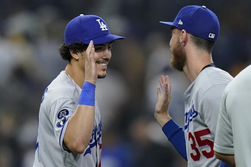 Los Angeles Dodgers left fielder Miguel Vargas, left, celebrates with center fielder Cody Bellinger after the Dodgers defeated the San Diego Padres 5-2 in a baseball game Thursday, Sept. 29, 2022, in San Diego. (AP Photo/Gregory Bull)