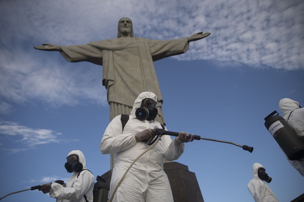 Soldiers disinfect the Christ the Redeemer site, currently closed, to prepare for what tourism officials hope will be a surge in visitors in the upcoming weekend as health restrictions are eased amid the new coronavirus pandemic in Rio de Janeiro, Brazil, Thursday, Aug. 13, 2020. (AP Photo/Silvia Izquierdo)