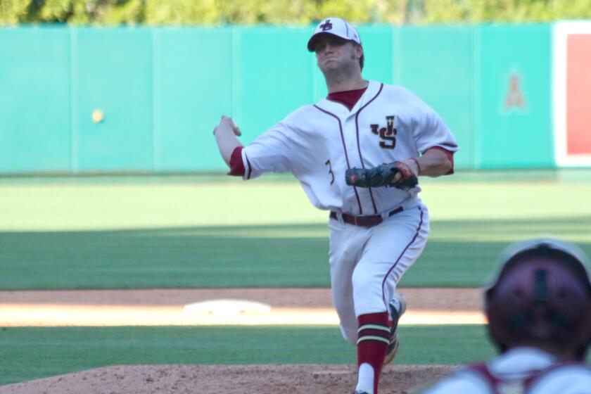 Junipero Serra starting pitcher Collin Quinn fires a warmup toss during a game against St. John Bosco at Angel Stadium.