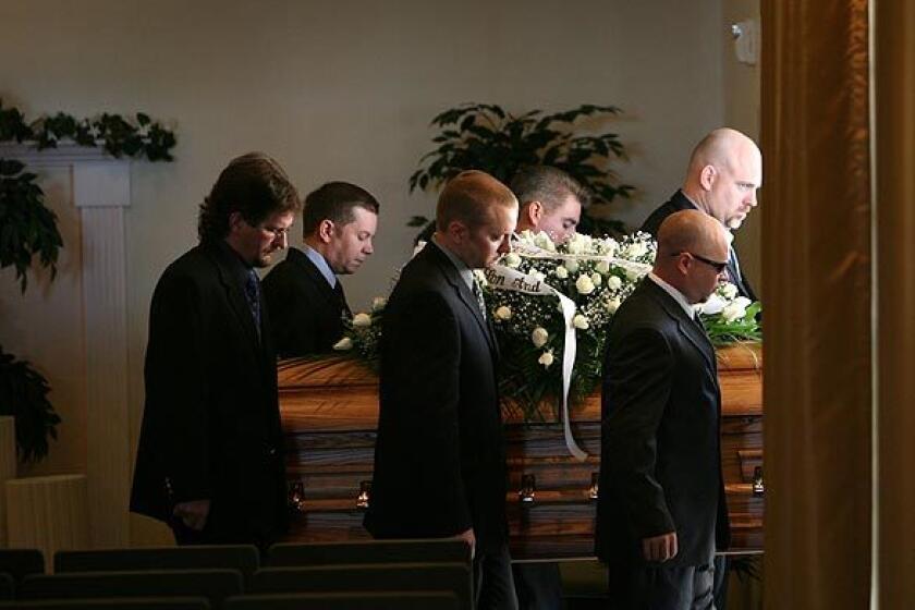 Christopher Aiken's brothers and close childhood friends serve as pallbearers at his funeral Saturday morning. The chapel was overflowing as dozens turned out to remember him at Conejo Mountain Memorial Park.