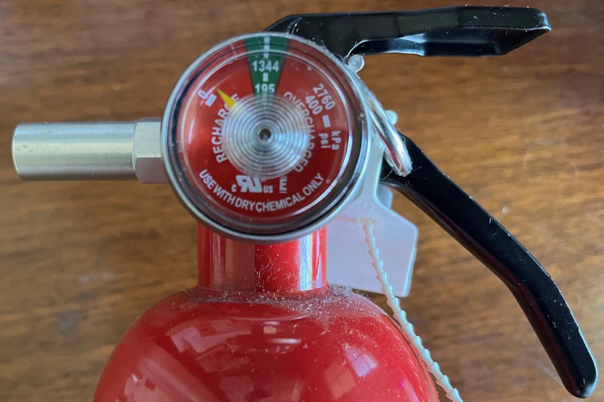 Close up photograph of fire extinguisher gauge with a reading indicating a recharge is needed.