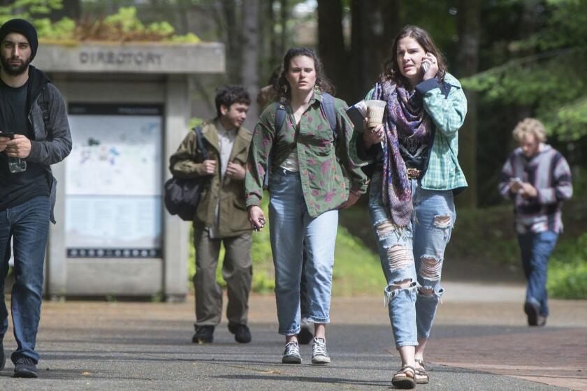 FILE - In this June 1, 2017 file photo, students leave the Evergreen State College campus in Olympia, Wash., after a threat prompted a student alert and evacuation. Threats have prompted the small college in Washington state to cancel classes Monday, June 5, 2017, for the third consecutive weekday after protests on the progressive campus drew national attention. (Tony Overman/The Olympian via AP, File)