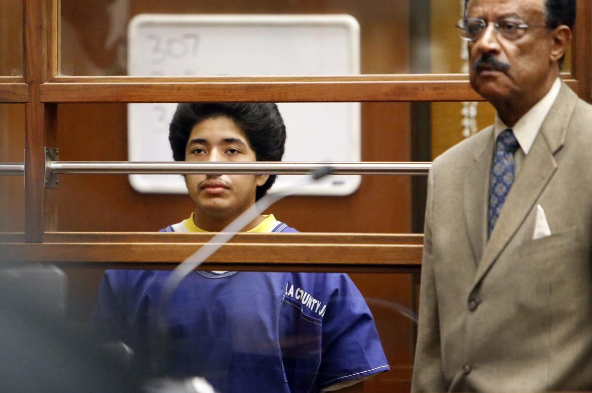 Jonathan DelCarmen, left, appears in Los Angeles Superior Court on Monday with his attorney Marvin J. Hamilton Jr., as one of four defendants being charged in connection to the 2014 beating death of USC graduate student Xinran Ji.