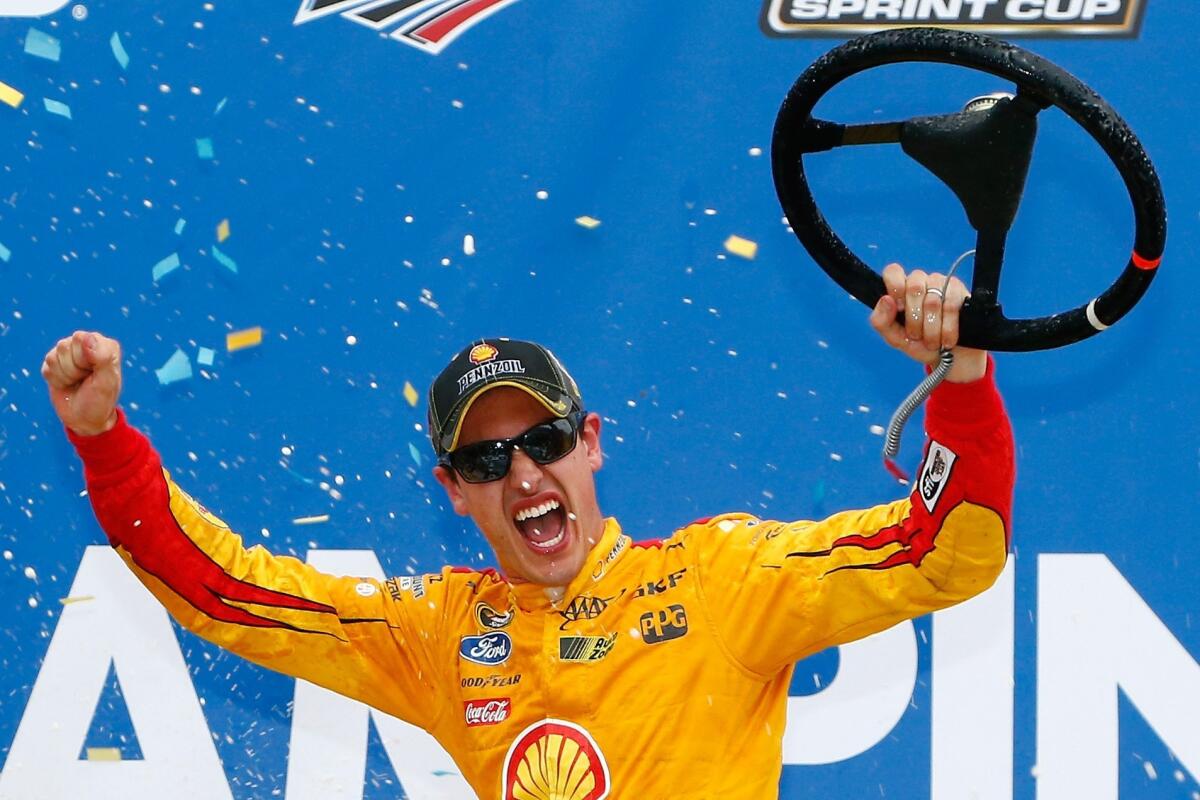 NASCAR driver Joey Logano celebrates after wining the Sprint Cup Series CampingWorld.com 500 at Talladega Superspeedway on Sunday.