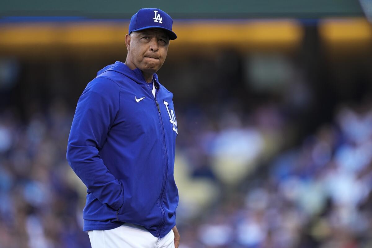 Dodgers manager Dave Roberts walks off the mound after a pitching change against the Atlanta Braves.
