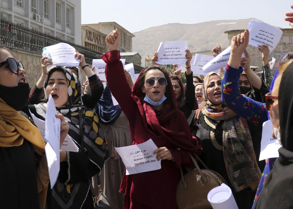 Women gather to demand their rights under the Taliban rule during a protest in Kabul, Afghanistan, Friday, Sept. 3, 2021. As the world watches intently for clues on how the Taliban will govern, their treatment of the media will be a key indicator, along with their policies toward women. When they ruled Afghanistan between 1996-2001, they enforced a harsh interpretation of Islam, barring girls and women from schools and public life, and brutally suppressing dissent. (AP Photo/Wali Sabawoon)