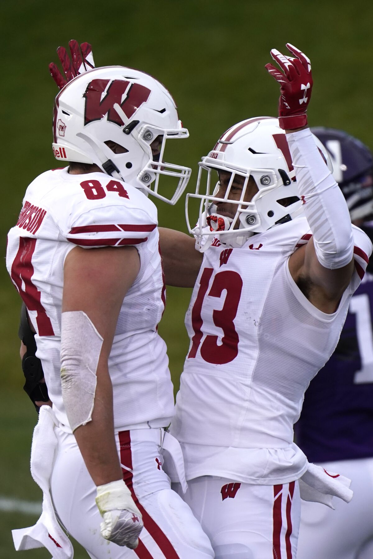 Wisconsin wide receiver Chimere Dike, right, celebrates with tight end Jake Ferguson after scoring touchdown during the first half of an NCAA college football game against Northwestern in Evanston, Ill., Saturday, Nov. 21, 2020. (AP Photo/Nam Y. Huh)