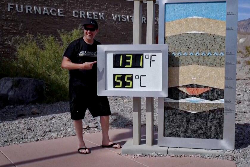 Death Valley temperatures soared to 128 degrees Sunday, breaking the daily record of 127 degrees set in 2005 and 1972. It was expected to hit 125 on Monday. (Associated Press)