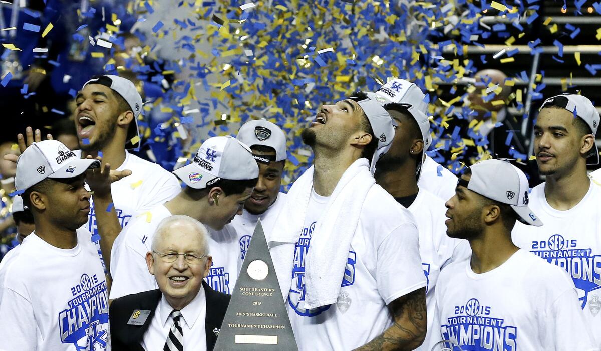 Kentucky forward Willie Cauley-Stein holds the trophy after the Wildcats won the Southeastern Conference tournament title Sunday in Nashville, Tenn. Many expect unbeaten Kentucky to sweep to the NCAA title.