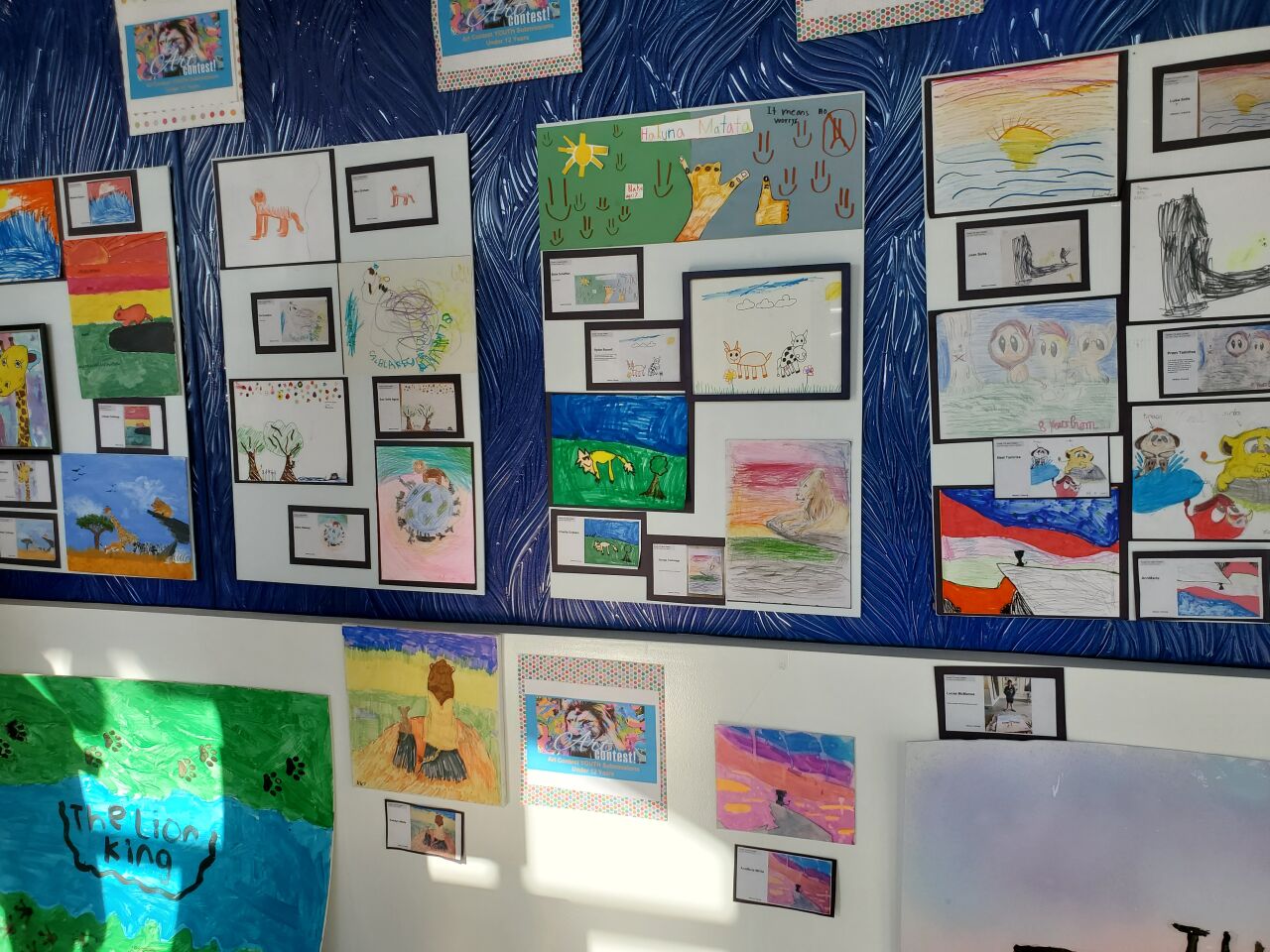Art submitted by children fills a wall at Pacific Sotheby's International Realty on Prospect Street in La Jolla.