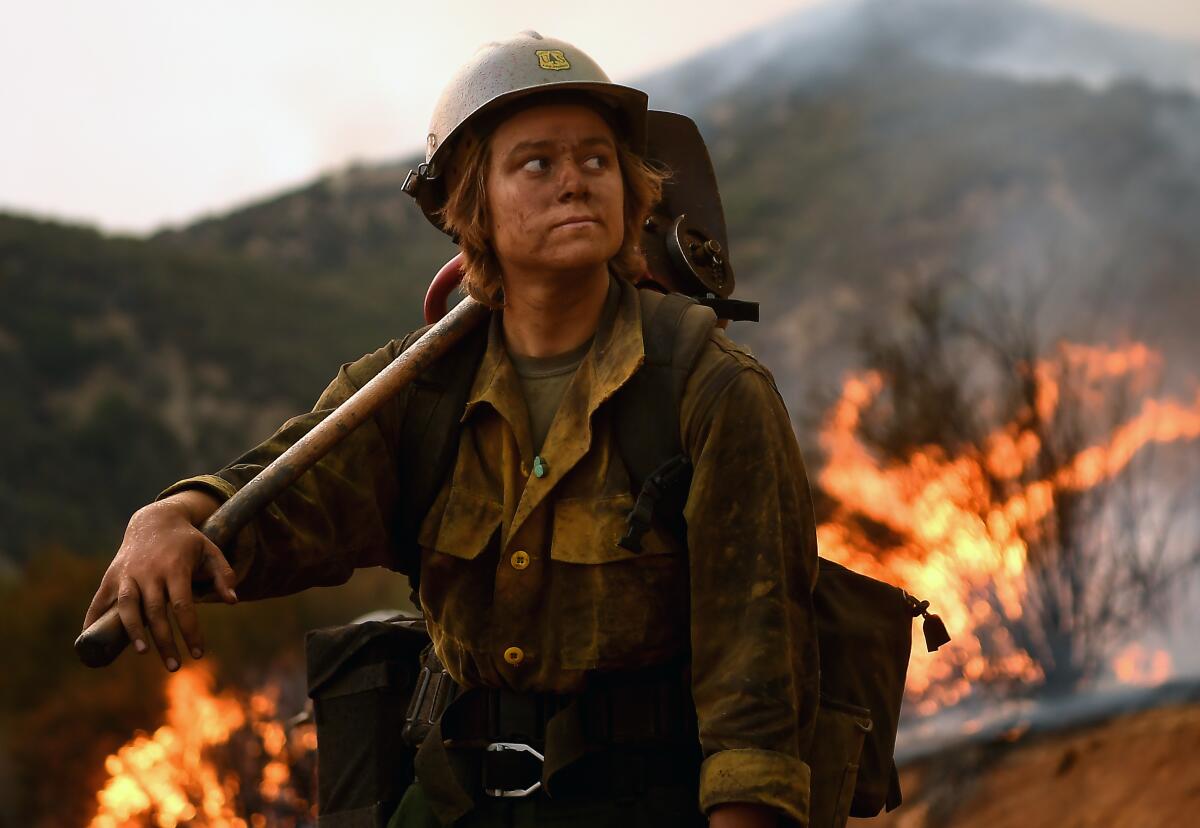 Arroyo Grande Hot Shot firefighter Shelby Robinette takes a break as crew members set back fires as the El Dorado Fire.