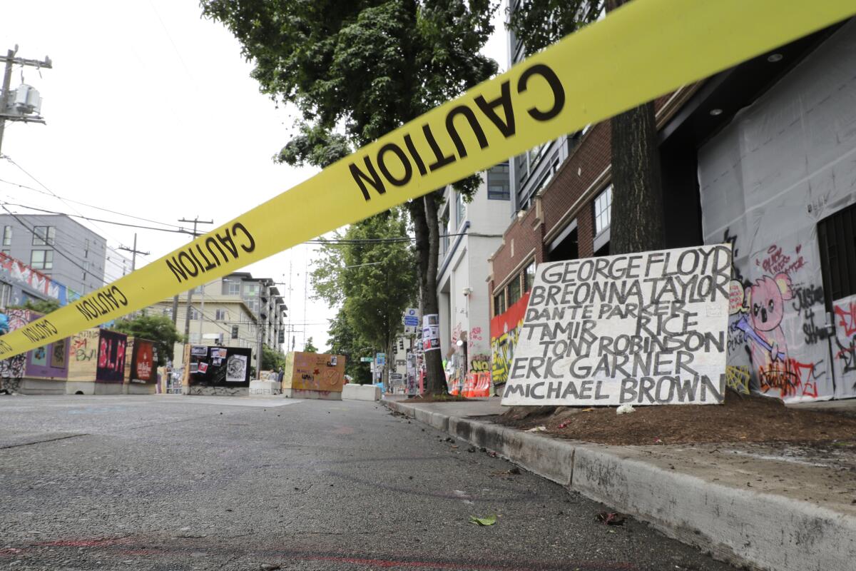 Caution tape marks an area in Seattle where a predawn shooting on Saturday left one man dead and another critically injured.