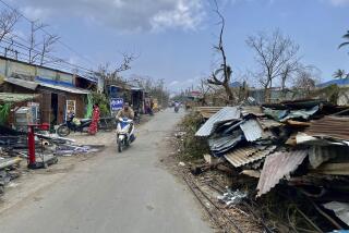 Local people ride motorbike along a roadside with damaged buildings after Cyclone Mocha in Sittwe township, Rakhine State, Myanmar, Friday, May 19, 2023. Cyclone Mocha roared in from the Bay of Bengal on Sunday with high winds and rain slamming a corner of neighboring Bangladesh and a wider swath of western Myanmar's Rakhine state. (AP Photo)