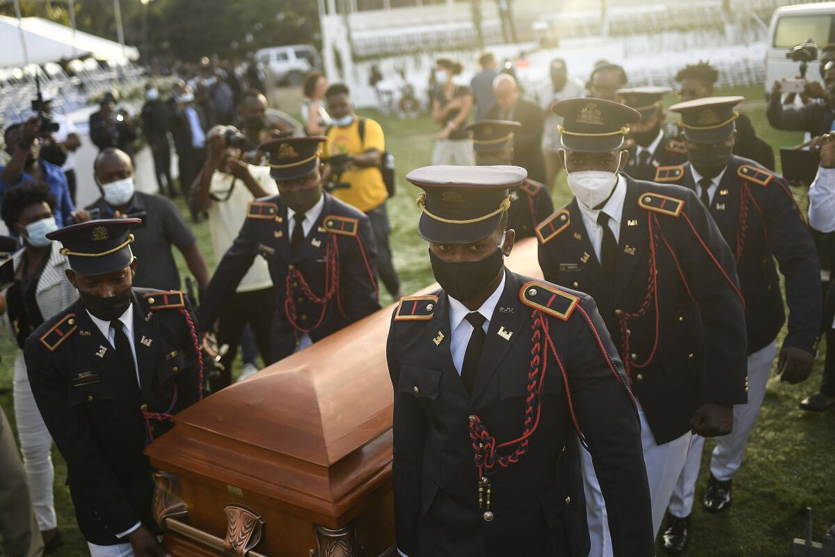 FILE - Police carry the coffin of slain Haitian President Jovenel Moise at the start of the funeral at his family home in Cap-Haitien, Haiti, early Friday, July 23, 2021. On Monday, Nov. 15, 2021, Turkish authorities issued a 40-day temporary custody order for a man considered a suspect in the July 7 assassination of Haitian President Jovenel Moise and placed him in a prison in Istanbul, Turkey's state-run news agency reported. (AP Photo/Matias Delacroix, File)