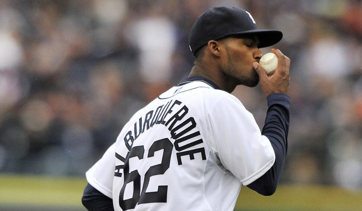 Detroit pitcher Al Alburquerque kisses the ball before throwing out Oakland's Yoenis Cespedes on Oct. 7, 2012.