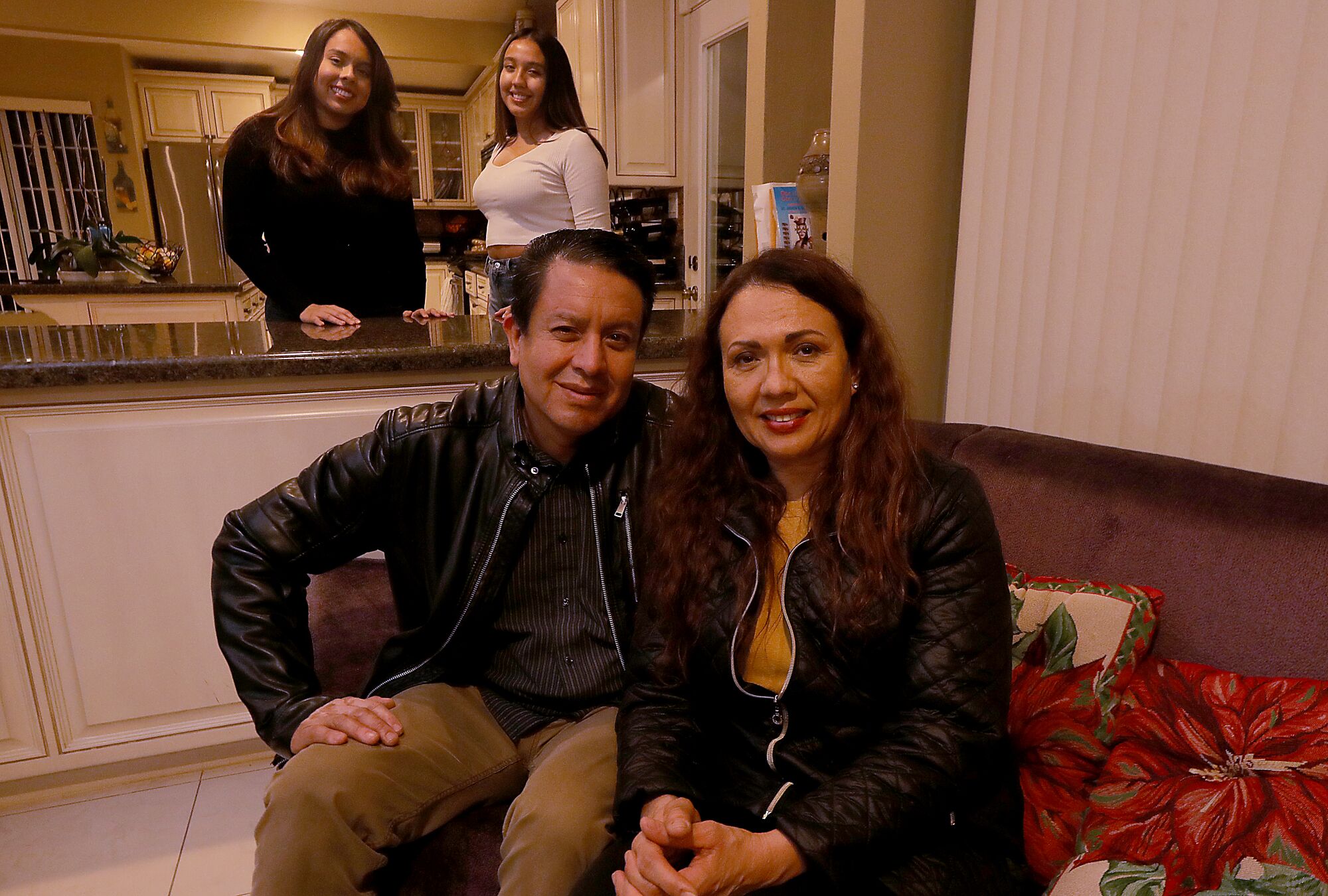 Carlos Salas y Gloria Verduzco en su casa junto a sus hijas, Ilianna, a la izquierda, y Paulina.