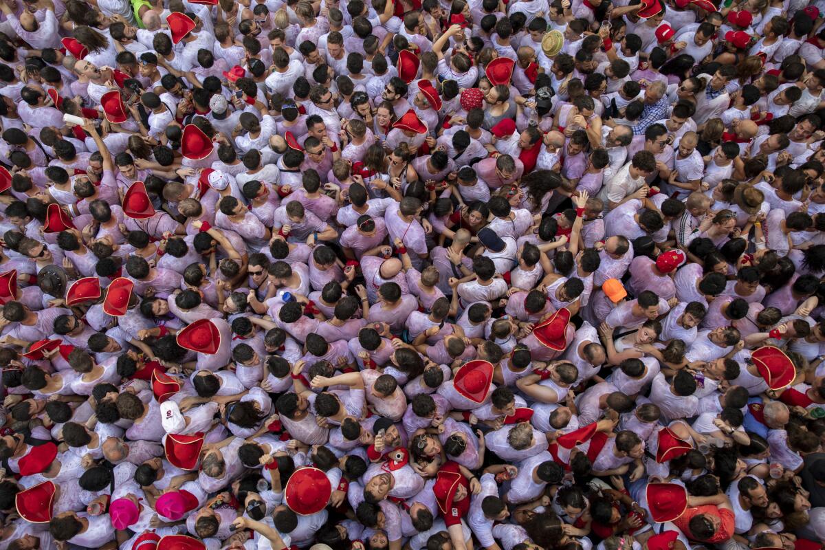 Revelers enjoy the atmosphere during the opening day of the San Fermin Festival in Pamplona, Spain. (Pablo Blazquez Dominguez / Getty Images)