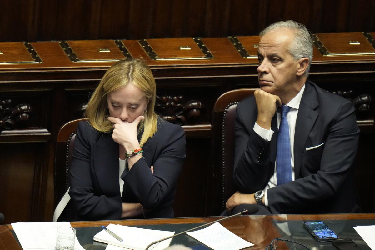 FILE - Italian Premier Giorgia Meloni, left, with Interior Minister Matteo Piantedosi at the lower Chamber on Oct. 25, 2022. Italy’s new interior minister on Wednesday, Nov. 2, 2022, defended a government decree banning rave parties against criticism it could be used to clamp down on sit-ins and other forms of protest, while taking no action against a march by thousands of fascist sympathisers to the crypt of Italy’s slain Fascist dictator. (AP Photo/Alessandra Tarantino)