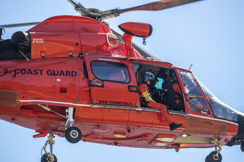 LAKE PIRU, CA - JULY 09: US Coast Guard helicopter crew searchers the shoreline at Lake Piru for missing actress Naya Rivera on Thursday, July 9, 2020 in Lake Piru, CA. (Brian van der Brug / Los Angeles Times)