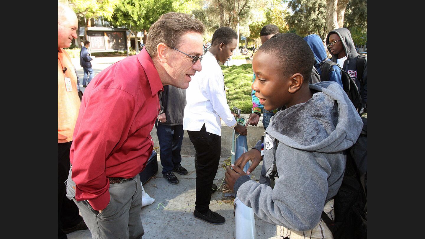 JPL scientist Paul Backes talks with Francis Msuya, of Tanzania, as the rest of the team tries to get their invention to work at JPL's annual Invention Challenge on Friday, December 2, 2016. 28 teams, including a team from Tanzania, but mostly of local Southern California schools, competed. The challenge was to transfer a specific amount of water over a distance to a collection cup on the other side. Methods included catapults, conveyor belts, a lot of duct tape, and pvc.