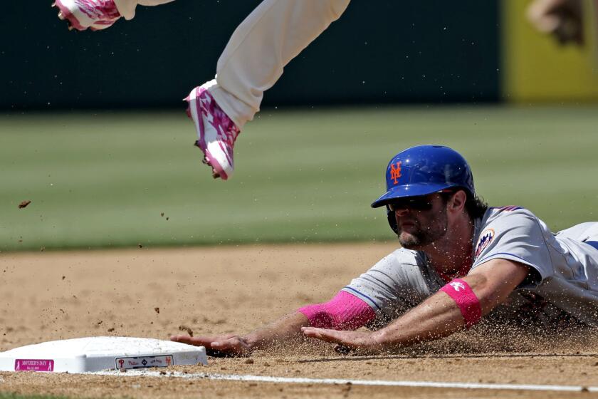 Outfielder Kirk Nieuwenhuis slides into third base during a Mets game against the Phillies on May 10.