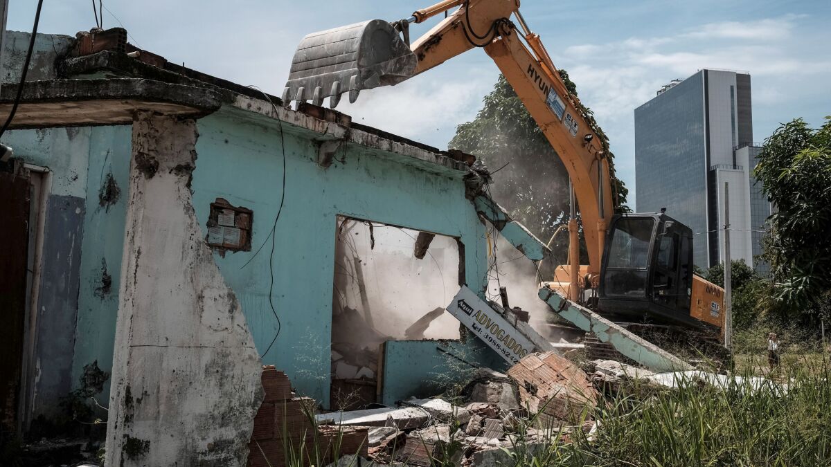 A home is demolished at Vila Autodromo, next to the construction site of the Olympic Park for the Rio 2016 Olympic Games. A passage connecting the Olympic Park with the Athletes Village is planned to be built on the site.
