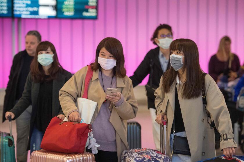 Passengers wear protective masks to protect against the spread of the Coronavirus as they arrive at the Los Angeles International Airport, California. - The United States asked China on January 28, 2020 to step up its cooperation with international health authorities over the outbreak of a deadly virus that has claimed more than 100 lives. "We are urging China -- more cooperation and transparency are the most important steps you can take toward a more effective response," Health and Human Services Secretary Alex Azar told reporters.